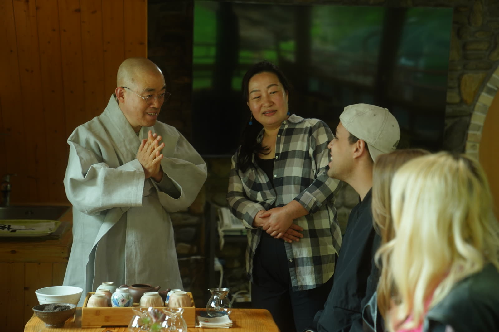 Guests talking with a monk over tea