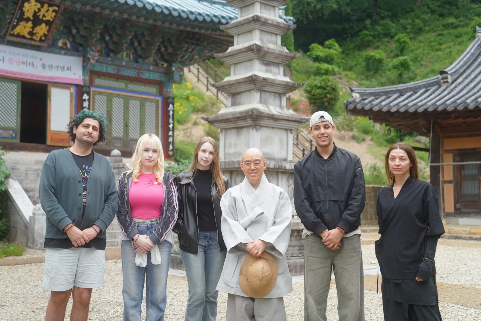 Guests with a monk in front of a temple pagoda